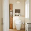 A bathroom scene with a toilet, a tall wooden cabinet, and a shower curtain. Produktbild-Vorschau