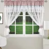 A window with curtains and a view of green grass outside.