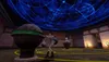 A woman in a video game is interacting with a large spherical object in a room with a celestial map on the ceiling. Produktbild-Vorschau