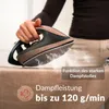 A person is using a steam iron on a brown fabric surface, with steam coming out of the iron. Produktbild-Vorschau