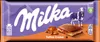 A Milka Toffee Creme chocolate bar wrapper with images of mountains, a cow, and a piece of chocolate. Podgląd zdjęcia produktu