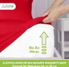 A hand is stretching a red fitted sheet over a mattress. Produktbild-Vorschau