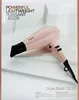 A pink BaByliss hair dryer is displayed on a white and light gray background with text describing its features. Náhled obrázku produktu