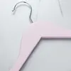 Close-up of a pink wooden hanger with a silver hook, set against a marble-like background. Produktbild-Vorschau