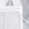 A close-up view of the top corner of a white fabric product, possibly a curtain or tote bag, with a clear plastic tube or rod inserted along the edge. Produktbild-Vorschau