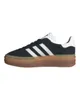 A side view of a black Adidas Gazelle Bold sneaker with white stripes and a gum sole, isolated on a white background. Anteprima dell’immagine prodotto