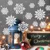 A festive Christmas display with hanging snowflakes, a blue lantern, a chalkboard with a Christmas message, and decorative ornaments. Produktbild-Vorschau