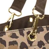 A close-up view of the top part of a leopard-print tote bag, showing the attachment points for the straps. Produktbild-Vorschau