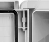 A close-up view of a hinge mechanism on a gray plastic enclosure. Produktbild-Vorschau