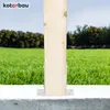 A wooden post is secured to a concrete base with metal brackets, set against a backdrop of green grass and trees. Anteprima dell’immagine prodotto