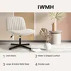 A light beige upholstered office chair is shown against a multi-colored background with decorative plants and a side table. Voir les images du produit