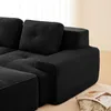 Close-up view of a black corduroy sofa armrest and cushions. Produktbild-Vorschau