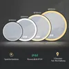 Four illuminated round mirrors of different sizes displayed in a row against a dark background. Produktbild-Vorschau