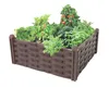 A raised garden bed filled with various plants, including tomatoes and leafy greens. Produktbild-Vorschau