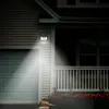A solar-powered motion-sensing wall light illuminates a garage door and the front porch of a house at night. Voir les images du produit