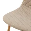 A close-up view of the textured fabric of a chair seat, showing stitching detail and a wooden leg. Náhľad obrázku produktu