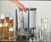 A hand is shown placing a glass into a glass washing device, with several beer glasses filled with beer in the background. Podgląd zdjęcia produktu