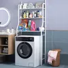 A bathroom shelf unit with various laundry and toiletry products sits above a washing machine. Podgląd zdjęcia produktu