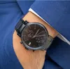 A close-up shot of a man's wrist wearing a black Tommy Hilfiger watch, with the sleeve of a blue suit jacket visible. Náhled obrázku produktu