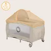 A baby crib with a mosquito net canopy. Produktbild-Vorschau