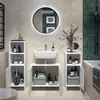 A modern bathroom with a sink, vanity, storage cabinets, and a round illuminated mirror. Voir les images du produit