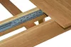A close-up view of the extension mechanism of a wooden dining table. Produktbild-Vorschau