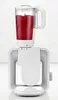 A white blender with a red smoothie in the pitcher sits on top of a white kitchen appliance base. Produktbild-Vorschau