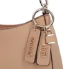 A close-up of a beige handbag with decorative charms. Produktbild-Vorschau