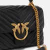 Close-up of a black quilted handbag with gold bird emblem and chain strap. Voir les images du produit