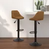 Two brown velvet bar stools are shown in a room with a white wall and wooden floor. Produktbild-Vorschau