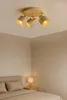 A ceiling light fixture with three adjustable spotlights is shown in a bedroom setting. Produktbild-Vorschau