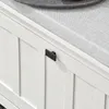 A close-up view of a white shoe bench with a black handle and a gray cushion. Produktbild-Vorschau