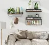 Shelves with decorative items and books mounted on a wall above a sofa. Produktbild-Vorschau