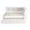 A white daybed with a pull-out trundle bed and a bookshelf headboard, shown from a slightly elevated front-side angle against a white background. Náhled obrázku produktu