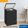 A black chest freezer is shown with its lid open, inside a room with a table and chair. Produktbild-Vorschau