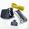 A collection of electronic accessories, including a power adapter, cables, and a plug adapter, laid out on a white surface. Podgląd zdjęcia produktu