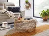 A living room scene with a couch, coffee table, and plants. Produktbild-Vorschau