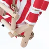 A close-up view of a wooden baby swing with red and white striped fabric. Produktbild-Vorschau