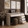 A modern desk setup with a laptop, lamp, and artwork on the wall. Produktbild-Vorschau