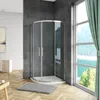 A modern bathroom with a curved glass shower enclosure, a rug, and a window with a scenic view. Produktbild-Vorschau