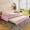 A pink upholstered daybed with a trundle bed pulled out, set in a bright room with a large window overlooking a green landscape. Podgląd zdjęcia produktu