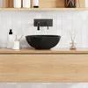 A modern bathroom vanity with a black ceramic sink and wooden drawer. Podgląd zdjęcia produktu