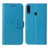 A blue flip cover phone case with a floral and butterfly embossed design is shown from the front and back. Produktbild-Vorschau