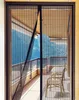 A magnetic screen door is partially open, revealing a balcony with chairs and a table, and a view of mountains beyond. Náhled obrázku produktu