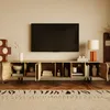 A modern living room with a TV stand, TV, lamp, and rug. Voir les images du produit