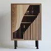 A wooden cabinet with shelves and decorative vertical slats, featuring two wine glasses and a wine bottle. It is supported by black legs. Produktbild-Vorschau