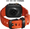 The back of an orange and black smartwatch band with the watch attached. Voir les images du produit
