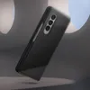 A black Samsung phone case is shown at an angle against a gray, abstract background. Náhled obrázku produktu