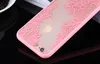 A close-up shot of a pink lace-designed phone case on a black reflective surface. Produktbild-Vorschau