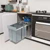 A kitchen scene with a pull-out trash system installed under the counter next to an oven. Voir les images du produit
